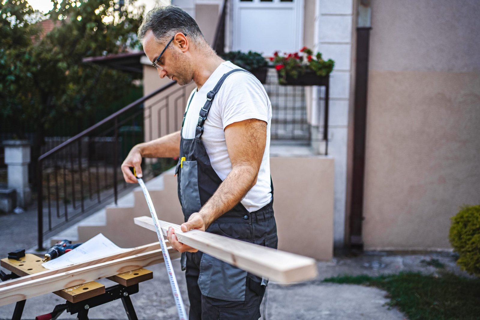 Mature male carpenter me working furniture project