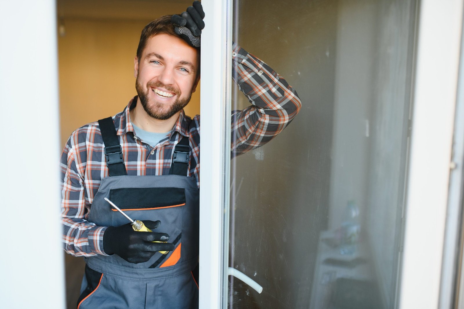 young repairman adjusting a terrace Sliding doors often pose common household repair challenges